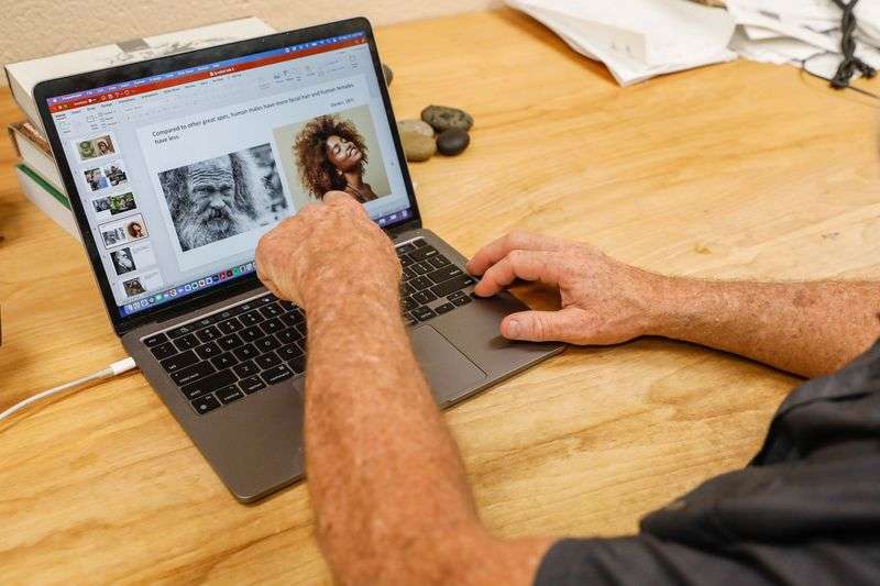 David Carrier, a professor of biology and co-author of
a study a study that explores how beards serve an evolutionary
purpose of protecting the jaw during fistfights, points to
study-relevant presentation slide in his office at the University
of Utah in Salt Lake City on Friday.