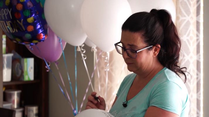 Summer Smart writes notes to her late son, Jordan Mair, on balloons before releasing them on his first heavenly birthday, July 26.