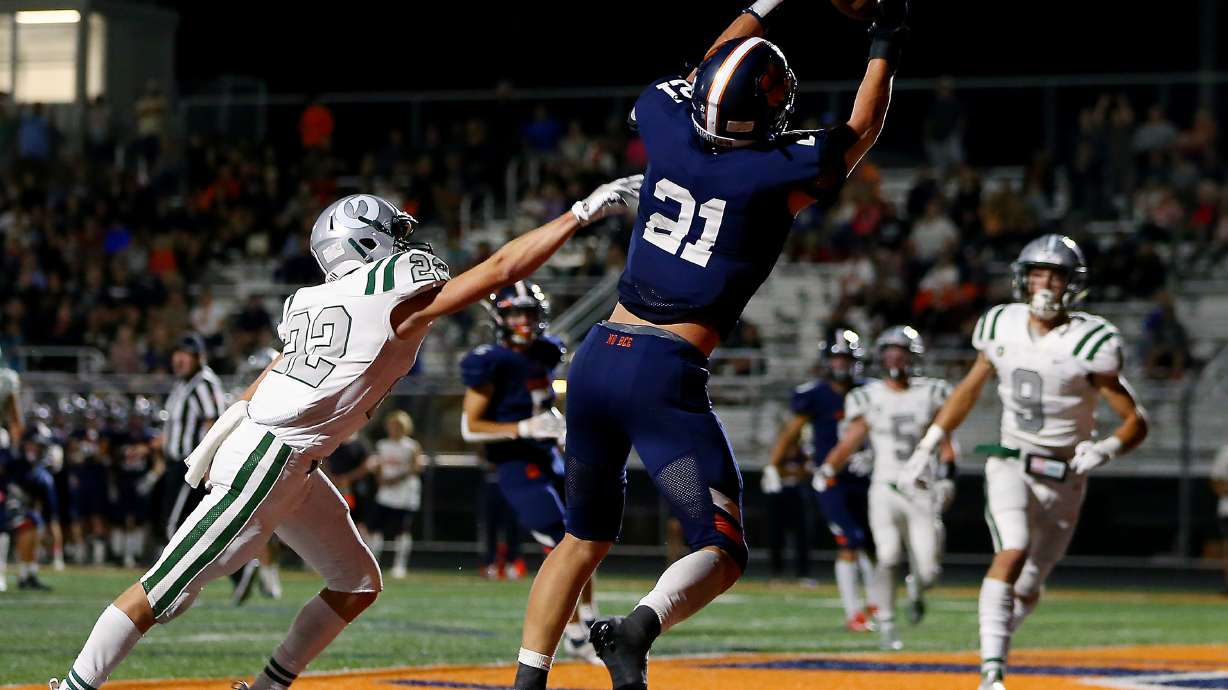 Brighton’s Lander Barton makes a catch for a touchdown over Olympus’ Ty Seagle as they play a high school football game at Brighton in Cottonwood Heights on Friday, Sept. 10, 2021. Olympus won 35-28.