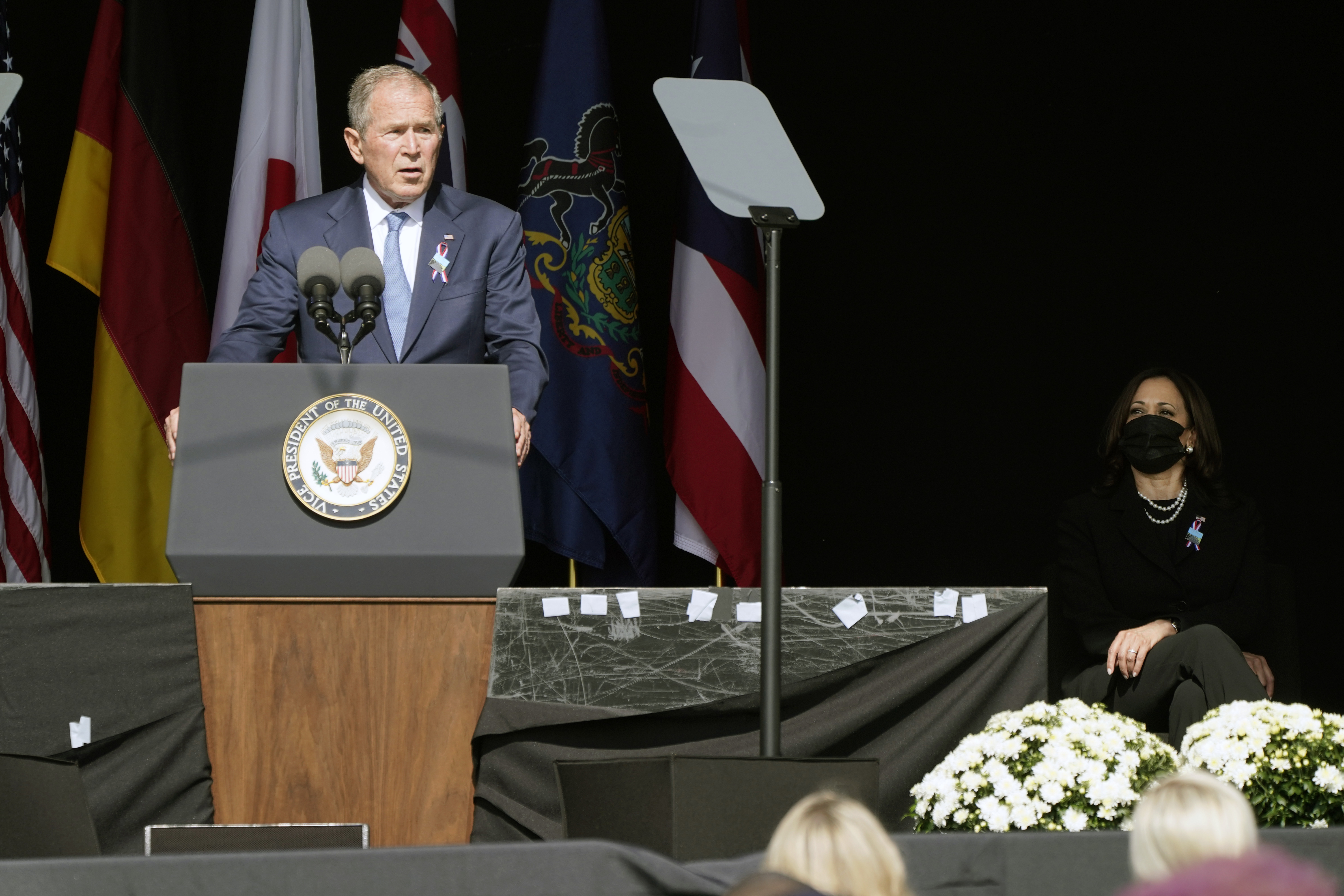 Former President George W. Bush speaks during a memorial for the passengers and crew of United Flight 93, Saturday in Shanksville, Pa., on the 20th anniversary of the Sept. 11, 2001 attacks, as Vice President Kamala Harris looks on, right.