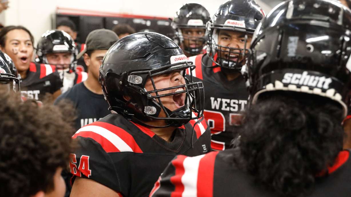 West’s Marcus Tua cheers with his teammates before exiting the locker room during a high school football game against Roy High on Friday, Sept. 10, 2021, at West High School in Salt Lake City.