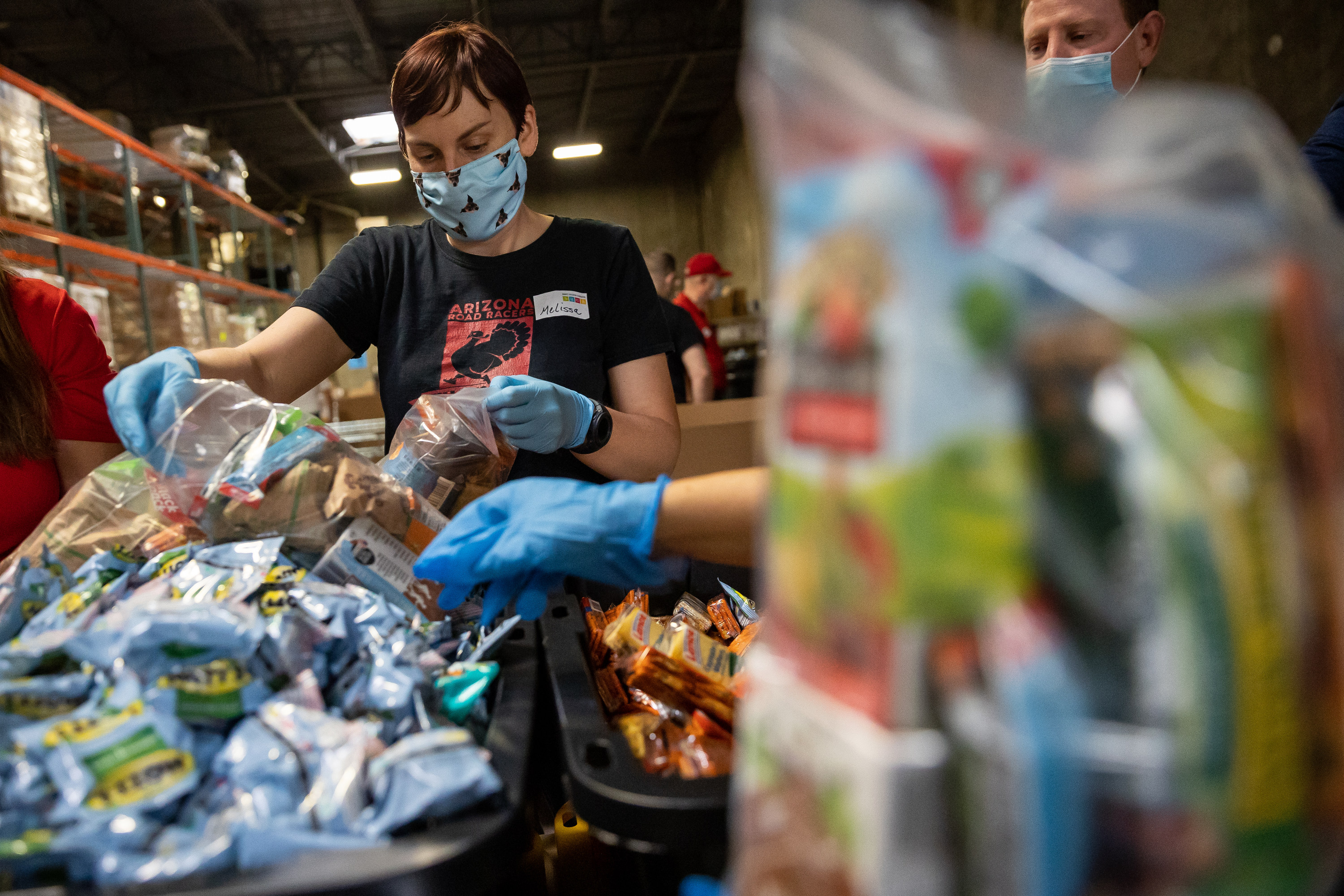 Melissa Black works to assemble meal and snack kits at the Granite Education Foundation's Donation and Distribution Center in West Valley City on Saturday.