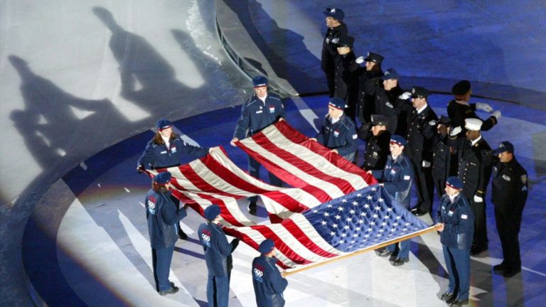 The World Trade Center flag is presented by members of the New York Police and Fire Department at the Opening Ceremonies of the Salt Lake 2002 Winter Olympic Games at Rice-Eccles Stadium Feb. 8, 2002. Sen. Mitt Romney recently reflected on how Sept. 11, 2001 impacted the Games.