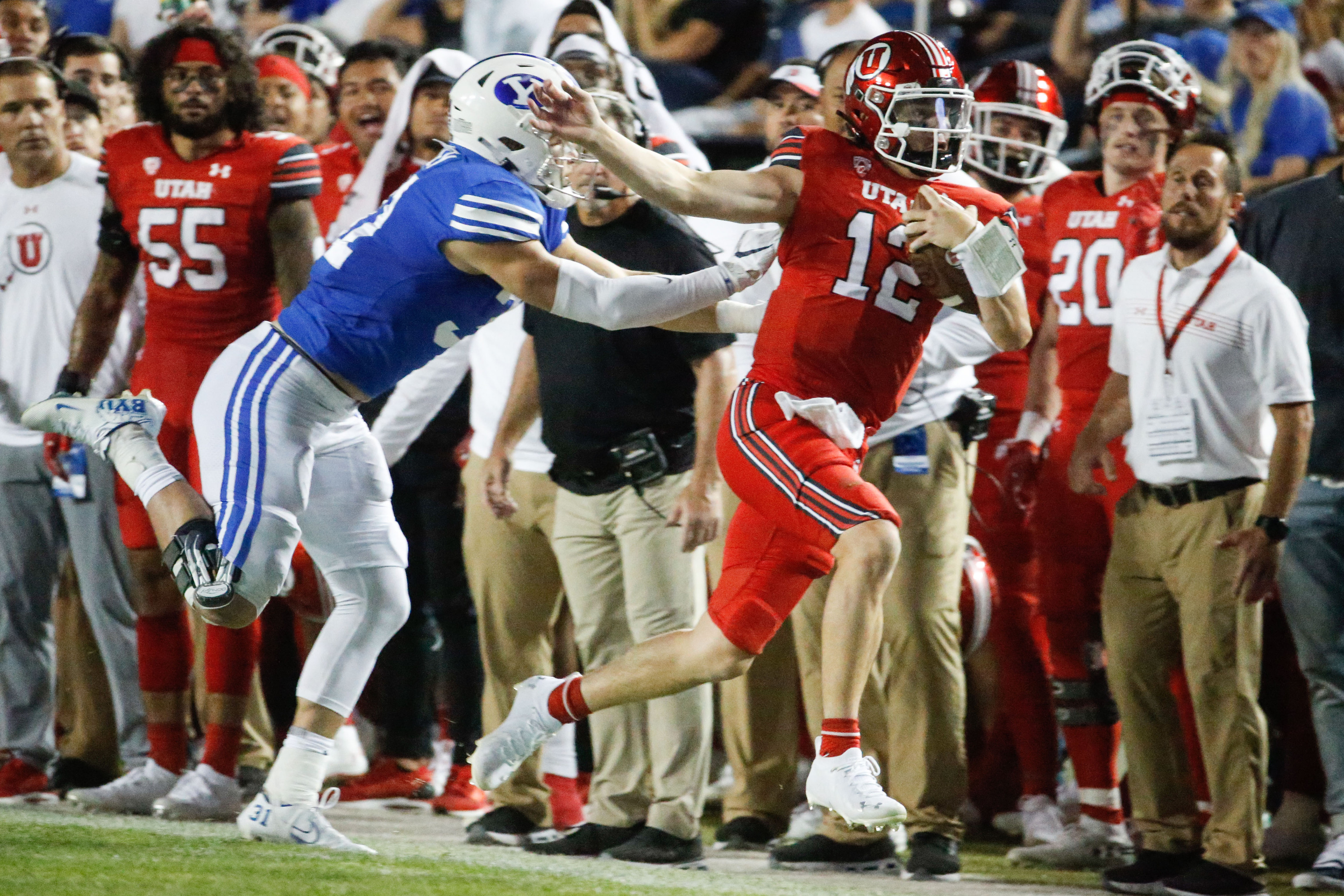 Utah Utes quarterback Charlie Brewer (12) sprints as BYU defends during the first half of an NCAA college football game at LaVell Edwards Stadium in Provo on Saturday, Sept. 11, 2021.
