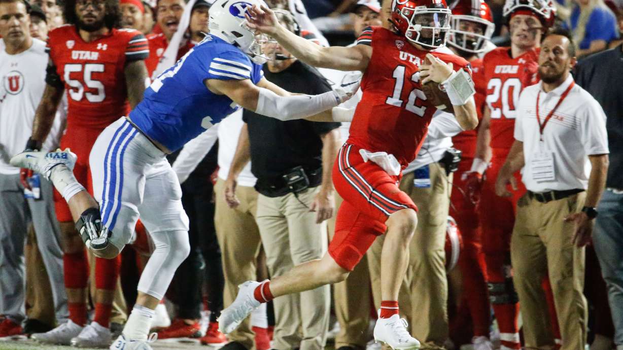 Utah Utes quarterback Charlie Brewer (12) sprints as BYU defends during the first half of an NCAA college football game at LaVell Edwards Stadium in Provo on Saturday, Sept. 11, 2021.