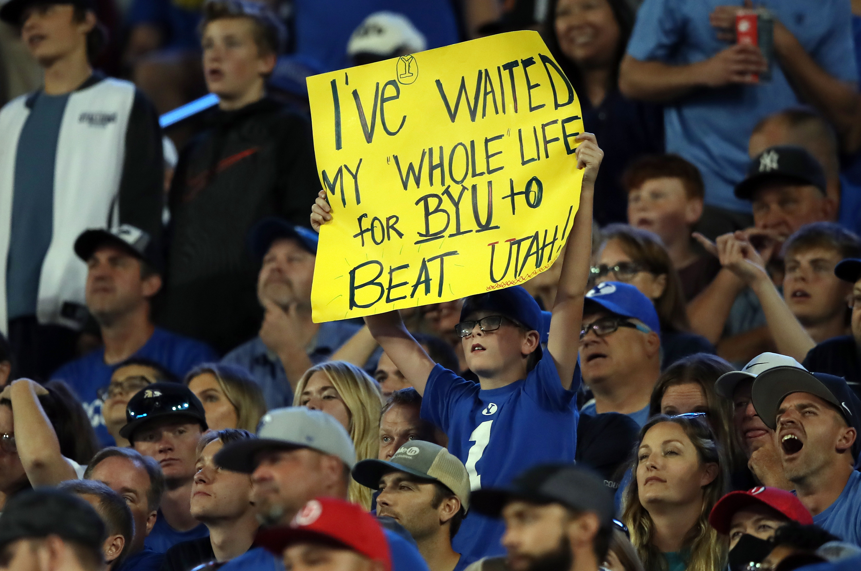 A young BYU fan holds up a sign as BYU and Utah play an NCAA football game at LaVell Edwards Stadium in Provo on Saturday, Sept. 11, 2021. BYU won 26-17, ending a nine-game losing streak to the Utes.