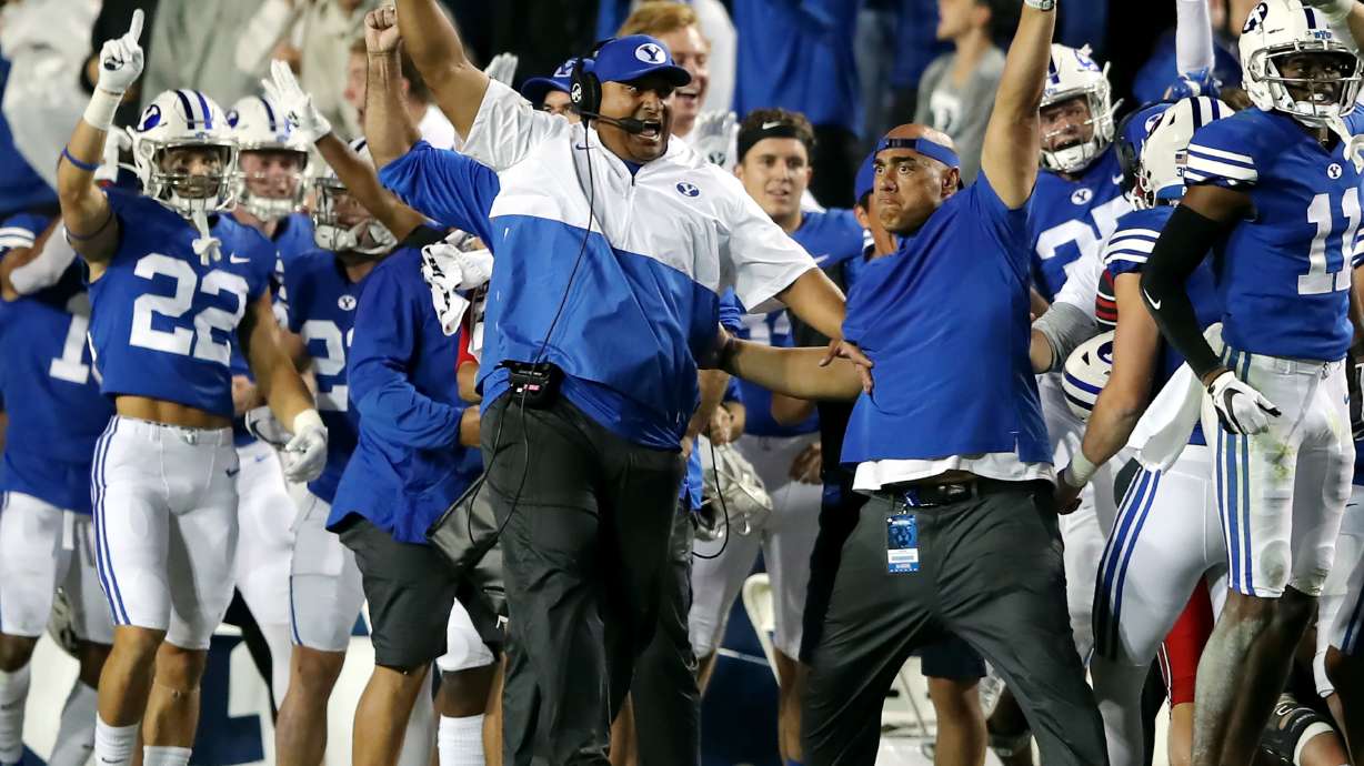 Brigham Young Cougars head coach Kalani Sitake and the rest of the BYU sideline begin to celebrate as they defeat Utah in an NCAA football game at LaVell Edwards Stadium in Provo on Saturday, Sept. 11, 2021. BYU won 26-17, ending a nine-game losing streak to the Utes.
