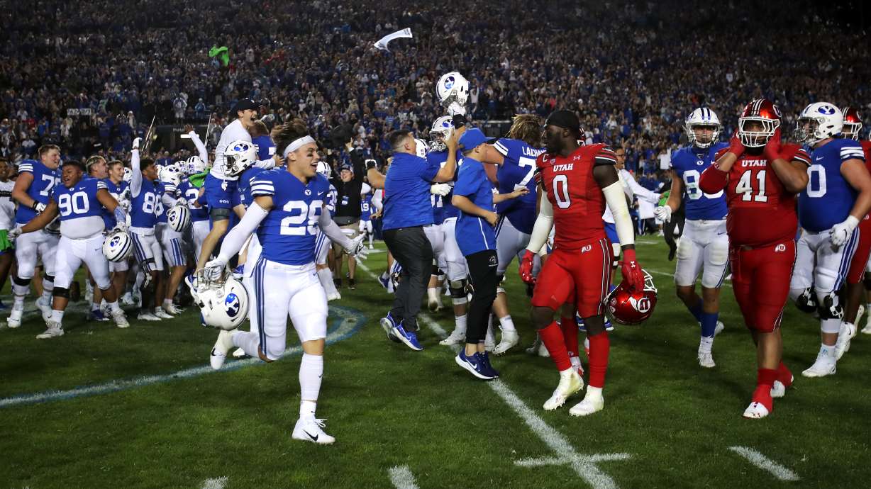 BYU players celebrate and Utah players look for the exit as they fall to the Cougars in an NCAA football game at LaVell Edwards Stadium in Provo on Saturday, Sept. 11, 2021. BYU won 26-17, ending a nine-game losing streak to the Utes.