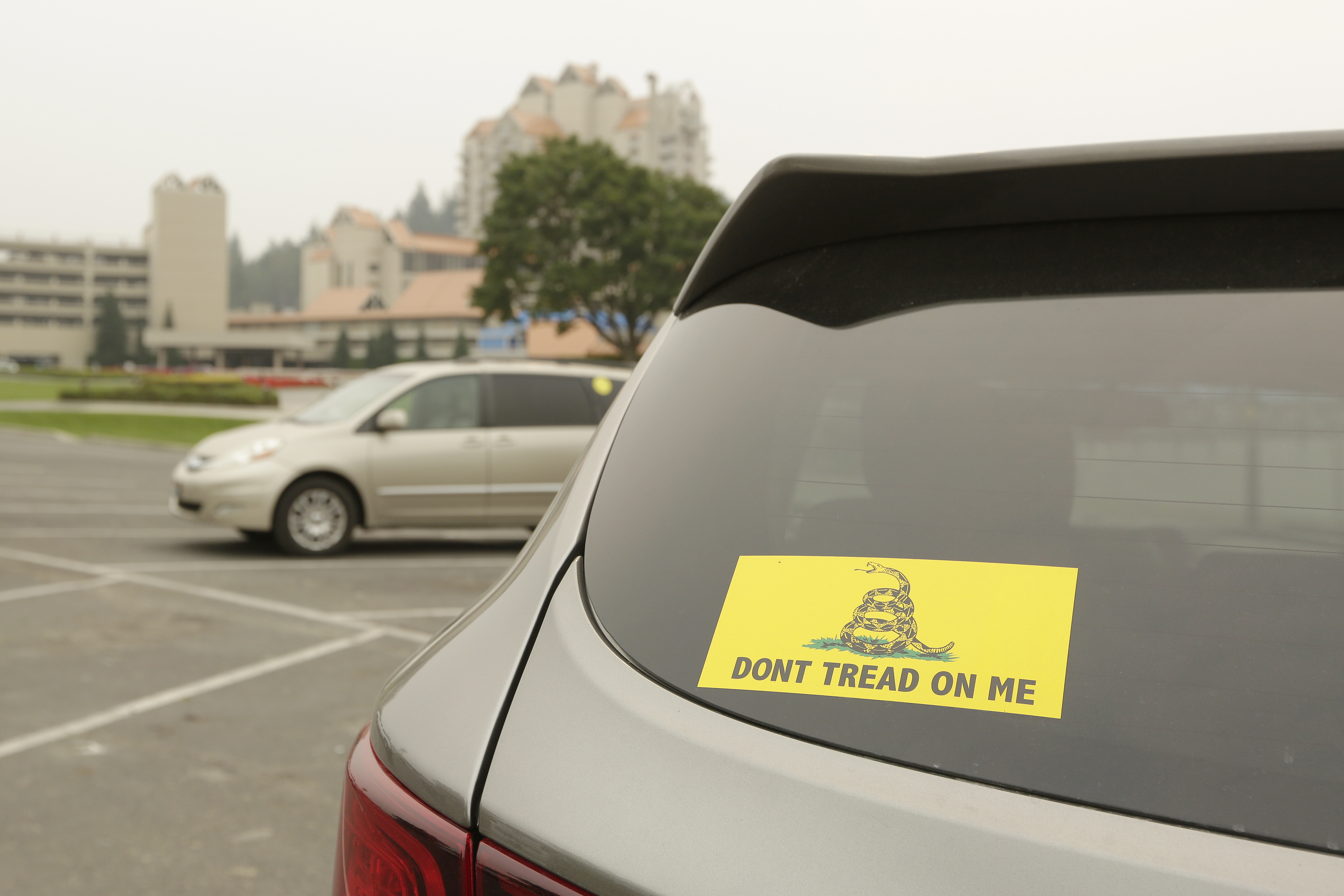 A vehicle with a Gadsden flag sticker is parked in the lot at Independence Point, Friday, in Coeur d'Alene, Idaho. Northern Idaho has a long and deep streak of antigovernment activism that is confounding attempts to battle a COVID-19 outbreak.