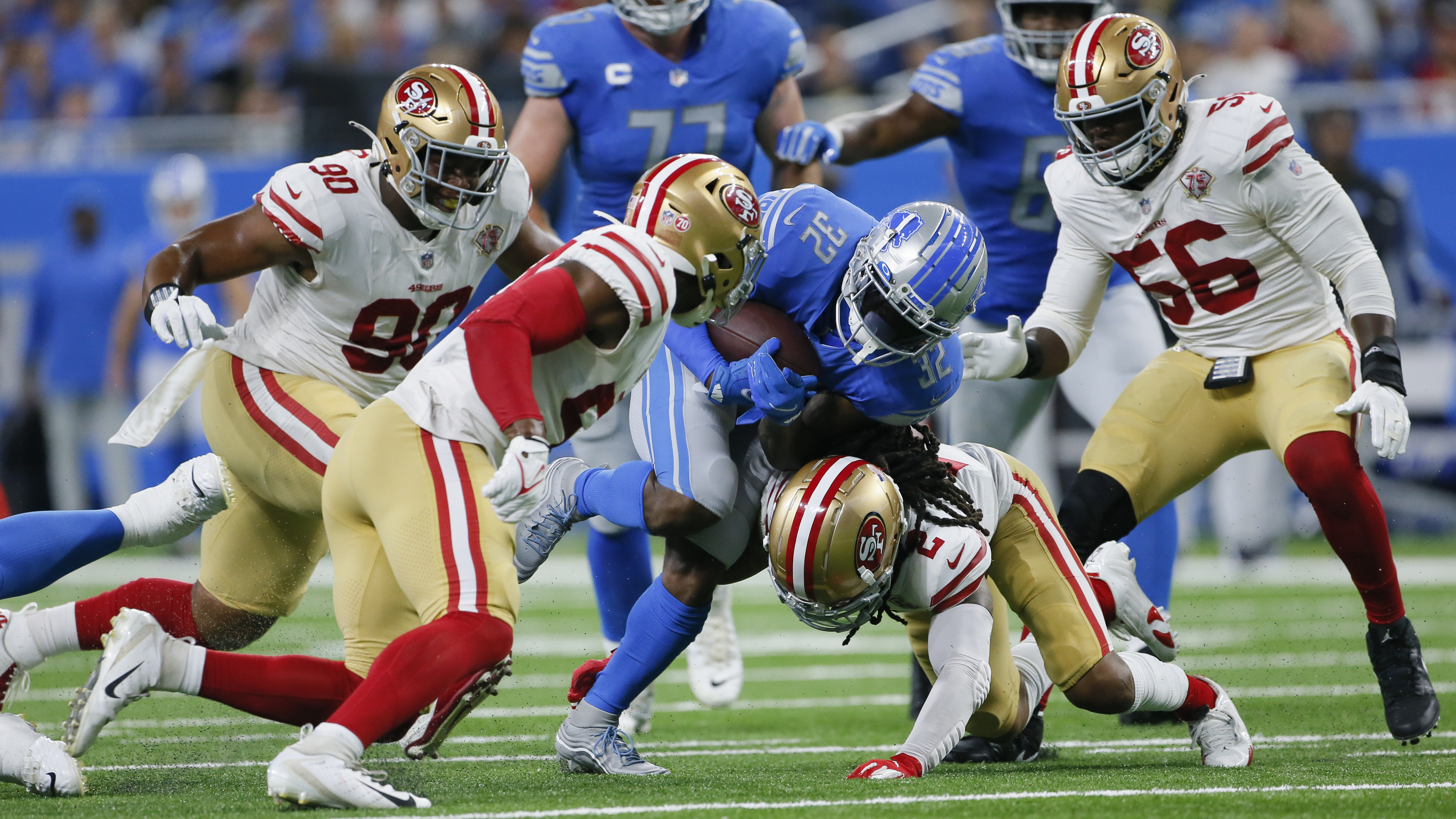 Detroit Lions running back D'Andre Swift (32) runs as San Francisco 49ers defensive back Jason Verrett (2) makes the tackle in the first half of an NFL football game in Detroit, Sunday, Sept. 12, 2021.