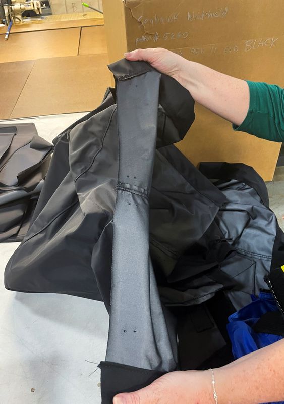 The cover for a helicopter rotor awaits a zipper for completion as the company's production has been delayed by shortages of once common supplies, at Diamond Brand factory in Fletcher, outside Asheville, North Carolina, Aug. 11.