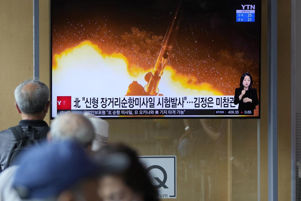 People watch a news program that was showing part of a North Korean handout photo that says, "North Korea's long-range cruise missiles tests," in Seoul, South Korea, Monday, Sept. 13, 2021. North Korea says it successfully test-fired newly developed long-range cruise missiles over the weekend, its first known testing activity in months, underscoring how it continues to expand its military capabilities amid a stalemate in nuclear negotiations with the United States. The letters read, "The North test-fired newly developed long-range cruise missiles."
