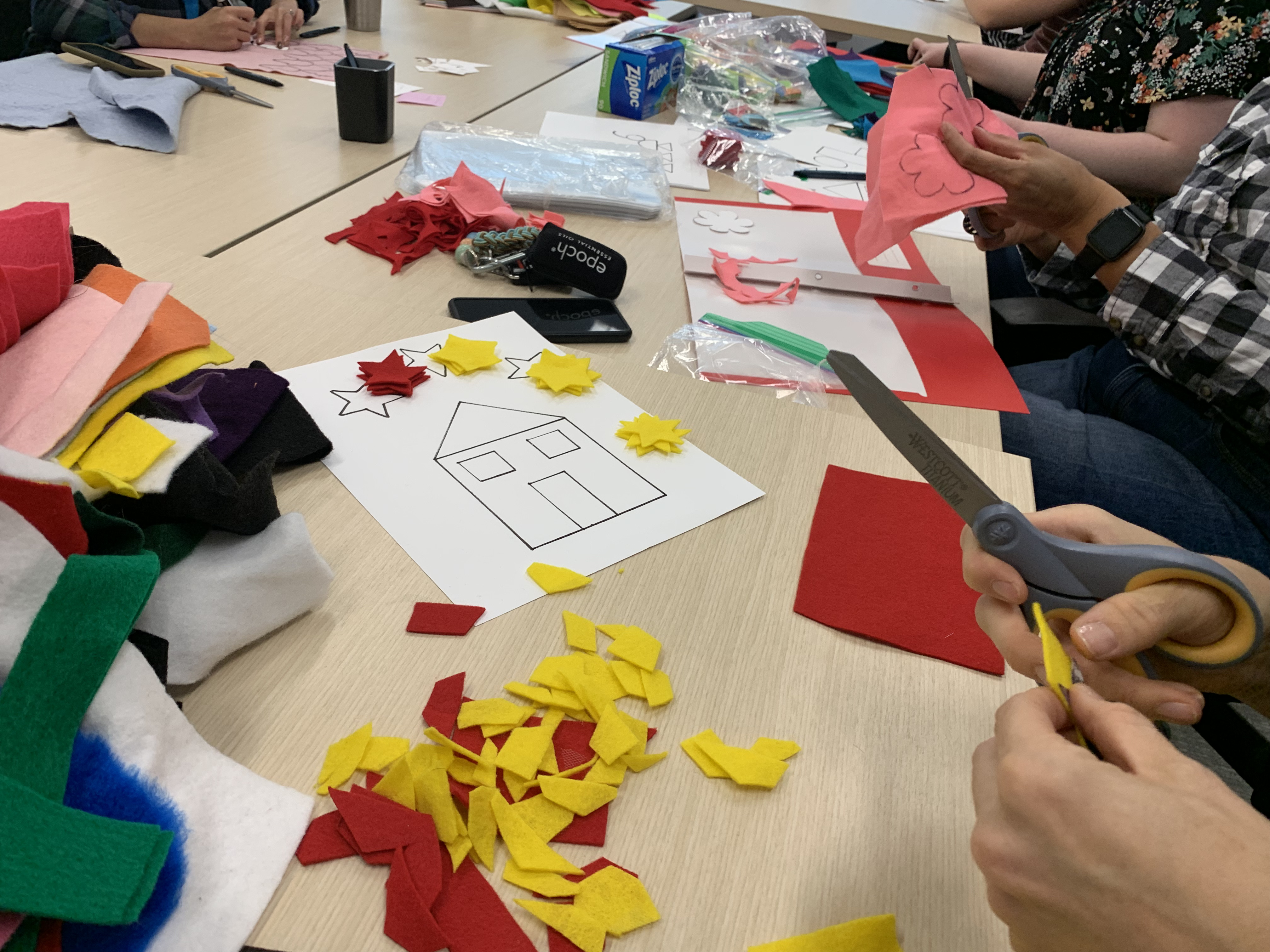 Marilyn Contreras-Pinegar and Shelly Hester cut felt shapes to be used in a language learning game for Afghan refugees on Monday in Salt Lake City.
