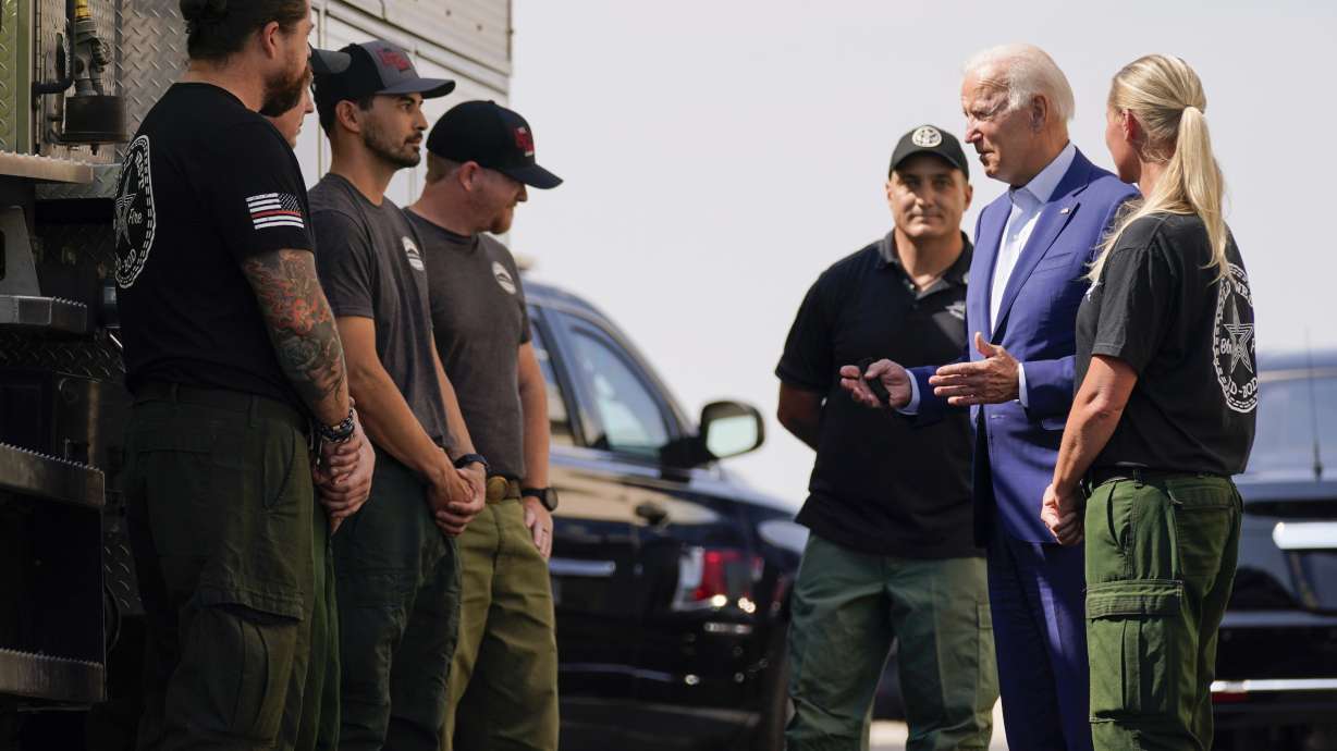 President Joe Biden greets firefighters as he tours the National Interagency Fire Center, Monday, Sept. 13, 2021, in Boise, Idaho.