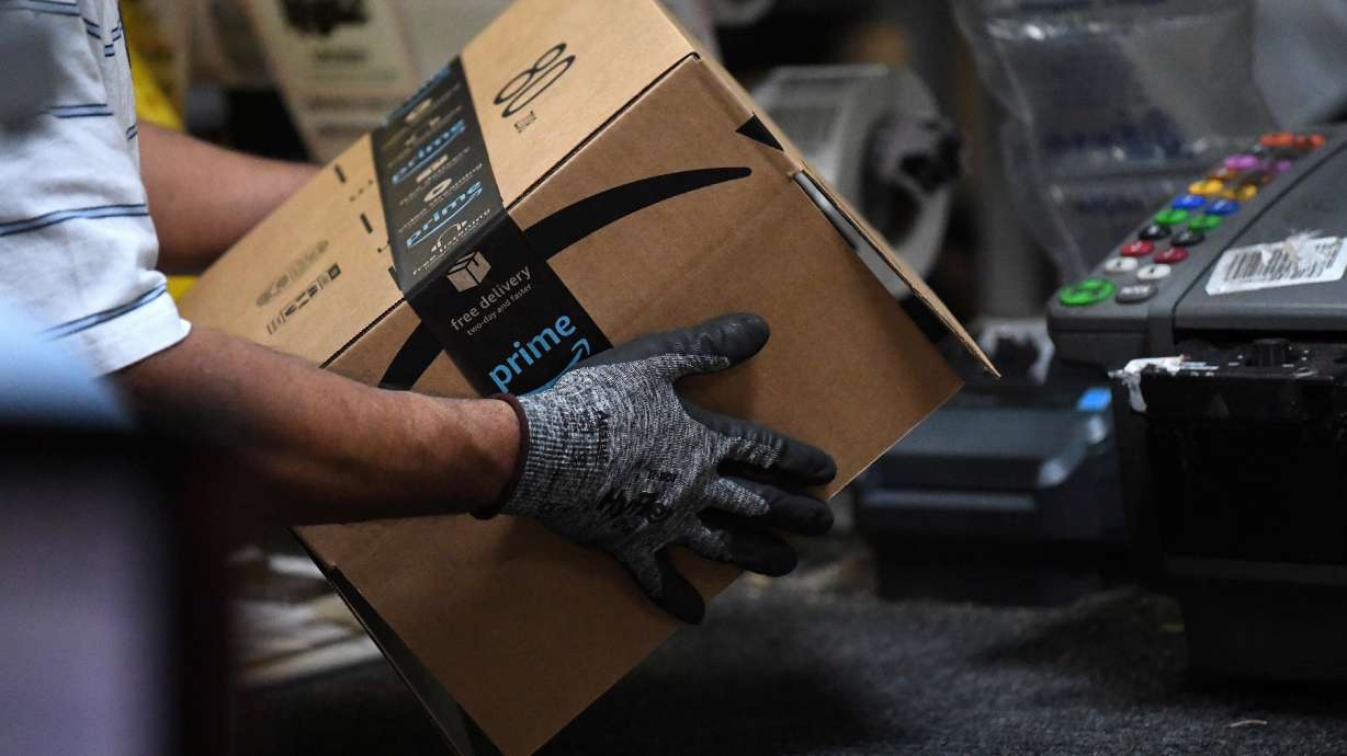 A worker assembles a box for delivery at the Amazon fulfillment center in Baltimore, Maryland, U.S., April 30, 2019. Amazon has increased its average starting wage in the United States to more than $18 an hour and plans to hire another 125,000 warehouse and transportation workers.