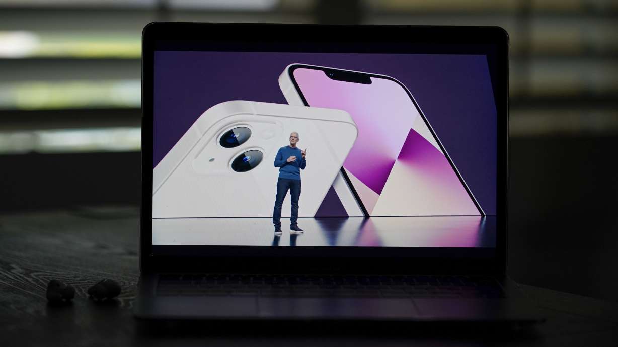 Seen on the screen of a device in La Habra, Calif., Apple CEO Tim Cook introduces the new iPhone 13 smartphones during a virtual event on Sept. 14. Cook will be a keynote speaker at the Silicon Slopes Summit in Salt Lake City on Oct. 13.