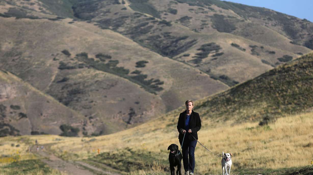 Melanie Malinka walks her dogs on the Bonneville Shoreline Access Trail in Salt Lake City on Sept. 14, 2021. It may be another year until construction of new foothill trails resumes, according to city officials.