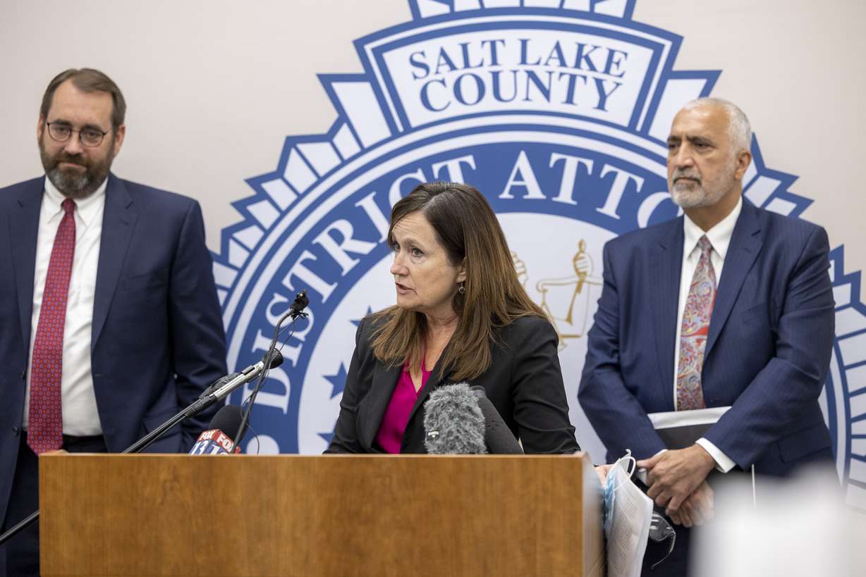 Utah County Attorney David Leavitt, left, and Salt Lake County District Attorney Sim Gill, right, listen as Summit County Attorney Margaret Olson discusses the death penalty in Utah at the Salt Lake County District Attorney’s Office building in Salt Lake City on Tuesday, Sept. 14, 2021, as Utah County Attorney David Leavitt looks on.