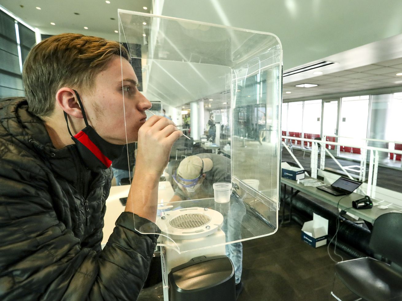 University of Utah freshman Daniel Wray swabs his nostril as he takes a rapid COVID-19 test at Rice-Eccles Stadium in
Salt Lake City on Friday, Nov. 20, 2020. Utah health officials confirmed 3,176 new COVID-19 cases and 23 deaths over the weekend.