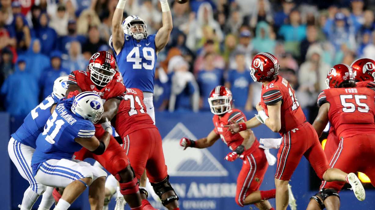 Brigham Young Cougars linebacker Payton Wilgar (49) knocks down a pass by Utah Utes quarterback Charlie Brewer (12) as BYU and Utah play an NCAA football game at LaVell Edwards Stadium in Provo on Saturday, Sept. 11, 2021. BYU won 26-17, ending a nine-game losing streak to the Utes.