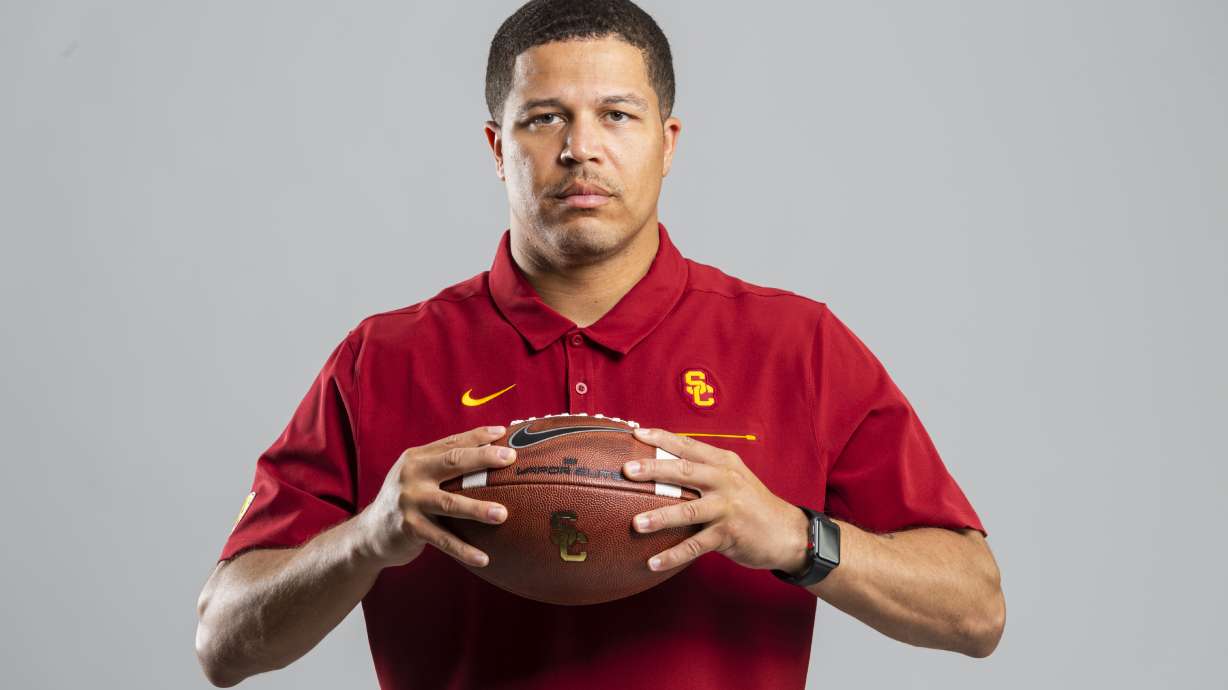 In this undated photo provided by the University of Southern California Athletics, USC associate coach Donte Williams poses in Los Angeles. Williams, the Trojans' cornerbacks coach and associate head coach, is taking over for the rest of the season alongside offensive coordinator Graham Harrell and defensive coordinator Todd Orlando, after the school fired head coach Clay Helton on Monday, Sept. 13, 2021.
