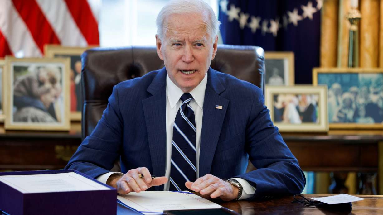 President Joe Biden signs the American Rescue Plan inside the Oval Office at the White House in Washington on March 11. A one-year expansion of the U.S. child tax credit, touted by Biden, has disproportionately benefited states that voted for former President Donald Trump in 2020, a review finds.