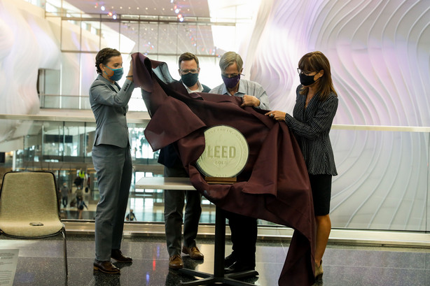 Salt Lake City Mayor Erin Mendenhall, left, Matt Needham, director of aviation and transportation at architecture, engineering and urban planning firm HOK, Bill Wyatt, executive director of the Salt Lake City Department of Airports, and Lisa Stanley, director of technical solutions for the U.S Green Business Council, unveil a LEED gold certification award during a celebration on Wednesday, Sept. 15, 2021, marking the first anniversary of the opening of Phase 1 of the Salt Lake City International Aiport.