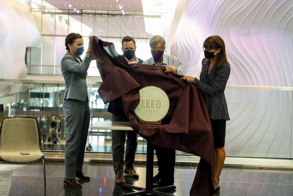 Salt Lake City Mayor Erin Mendenhall, left, Matt Needham, director of aviation and transportation at architecture, engineering and urban planning firm HOK, Bill Wyatt, executive director of the Salt Lake City Department of Airports, and Lisa Stanley, director of technical solutions for the U.S Green Business Council, unveil a LEED gold certification award during a celebration on Wednesday, Sept. 15, 2021, marking the first anniversary of the opening of Phase 1 of the Salt Lake City International Aiport.