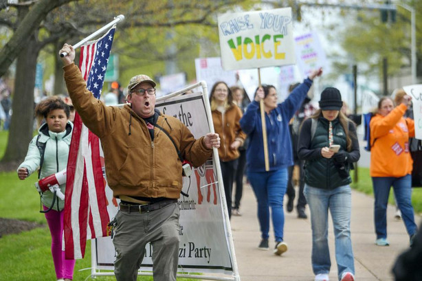 Opponents of a bill to repeal Connecticut's religious exemption for required school vaccinations march down Capitol Avenue before the State Senate voted on legislation, in Hartford, Conn, April 27. Religious objections, once used only sparingly around the country to get exempted from various required vaccines, are becoming a much more widely used loophole against the COVID-19 shot.