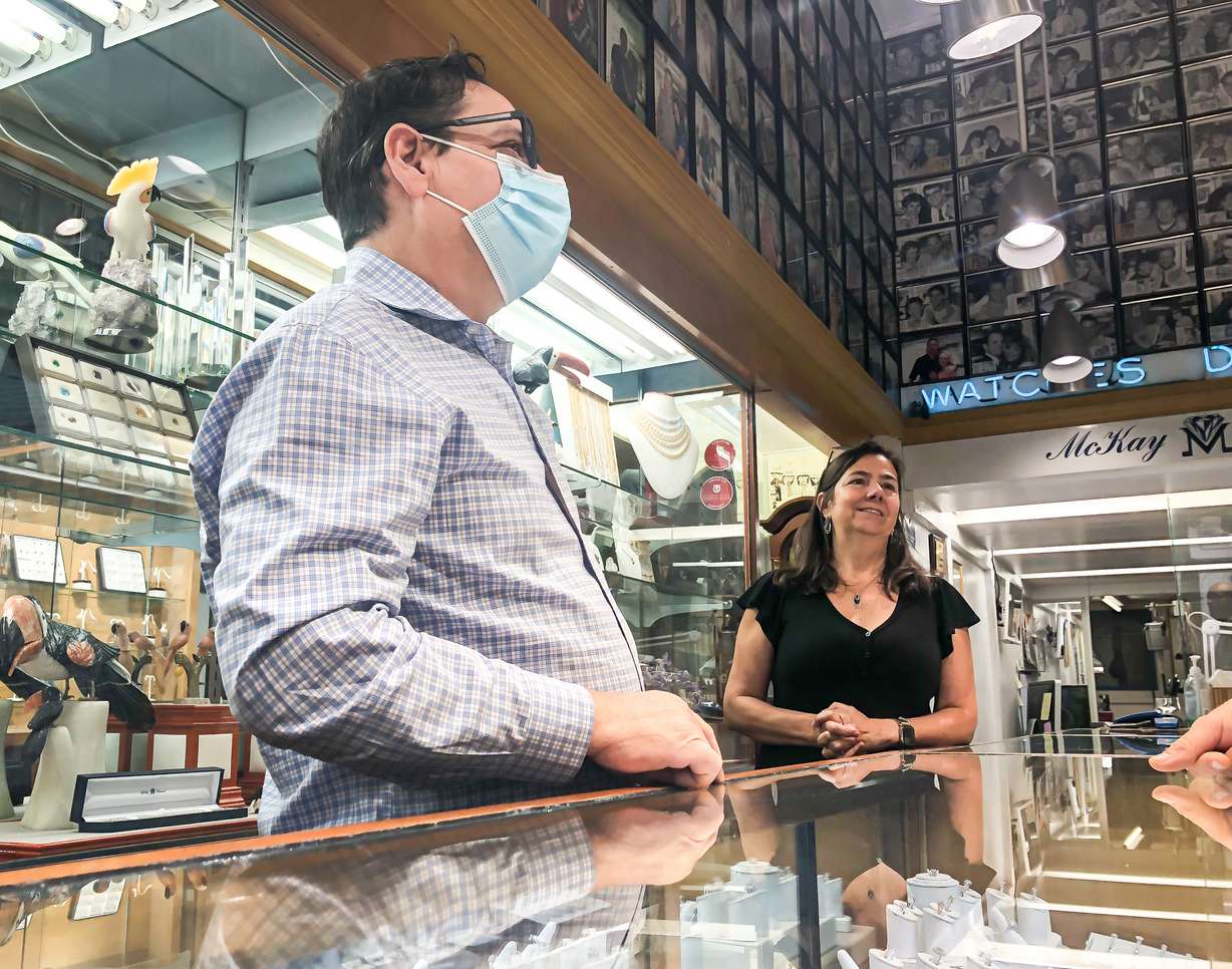 Joe and Sandra Andrade speak with a customer inside McKay Jewelers on Wednesday. The couple, originally from Brazil, has owned the store since 2010.