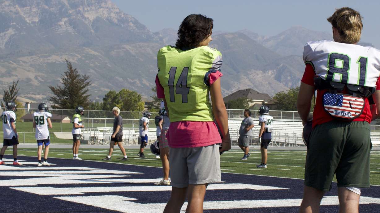 Timpanogos quarterback Matu Holdaway (14) and running back Josh Jones (81) during practice in Orem. The Timberwolves are off to a 5-0 start, their best since 2018 and one of just three years in the past seven with at least as many total wins.