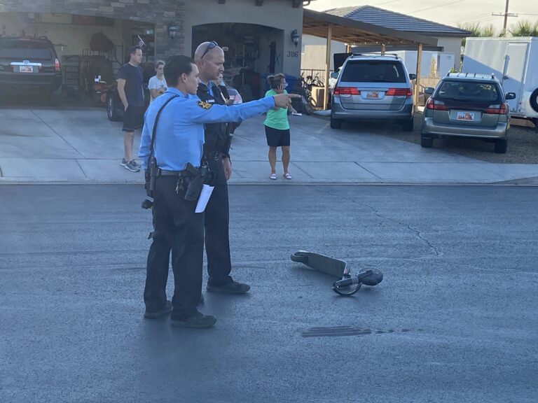 Police officers at the scene of a scooter and truck accident in St. George Thursday.