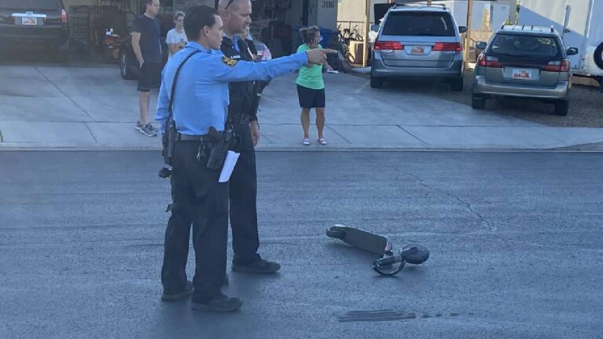 Police officers at the scene of a scooter and truck accident in St. George Thursday.