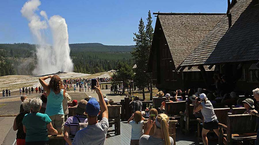 A crowd watches Old Faithful Geyser erupt. A Rhode Island woman was burned at Old Faithful Thursday.