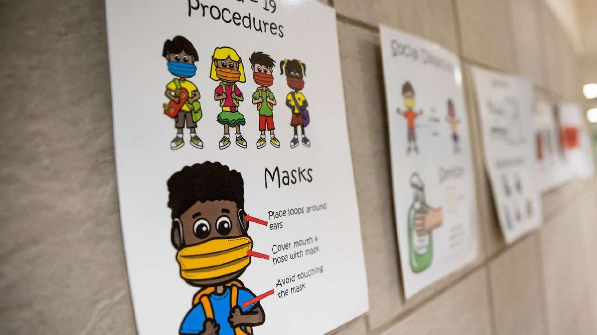 Signage reminds students of various COVID-19 procedures, like masking and social distancing, at Nibley Park School in Salt Lake City on Tuesday, Aug. 24, 2021. Long before COVID-19, Utah schools reported that the need for mental health services was far outstripping the supply.