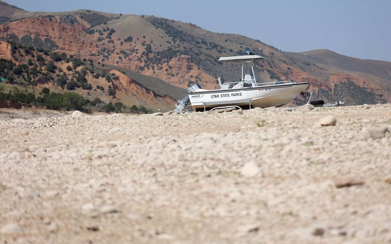 A Utah State Parks boat is parked on a trailer on the
dried-up shore of Echo Reservoir, which is currently at 12%
capacity, during a drought on Thursday.