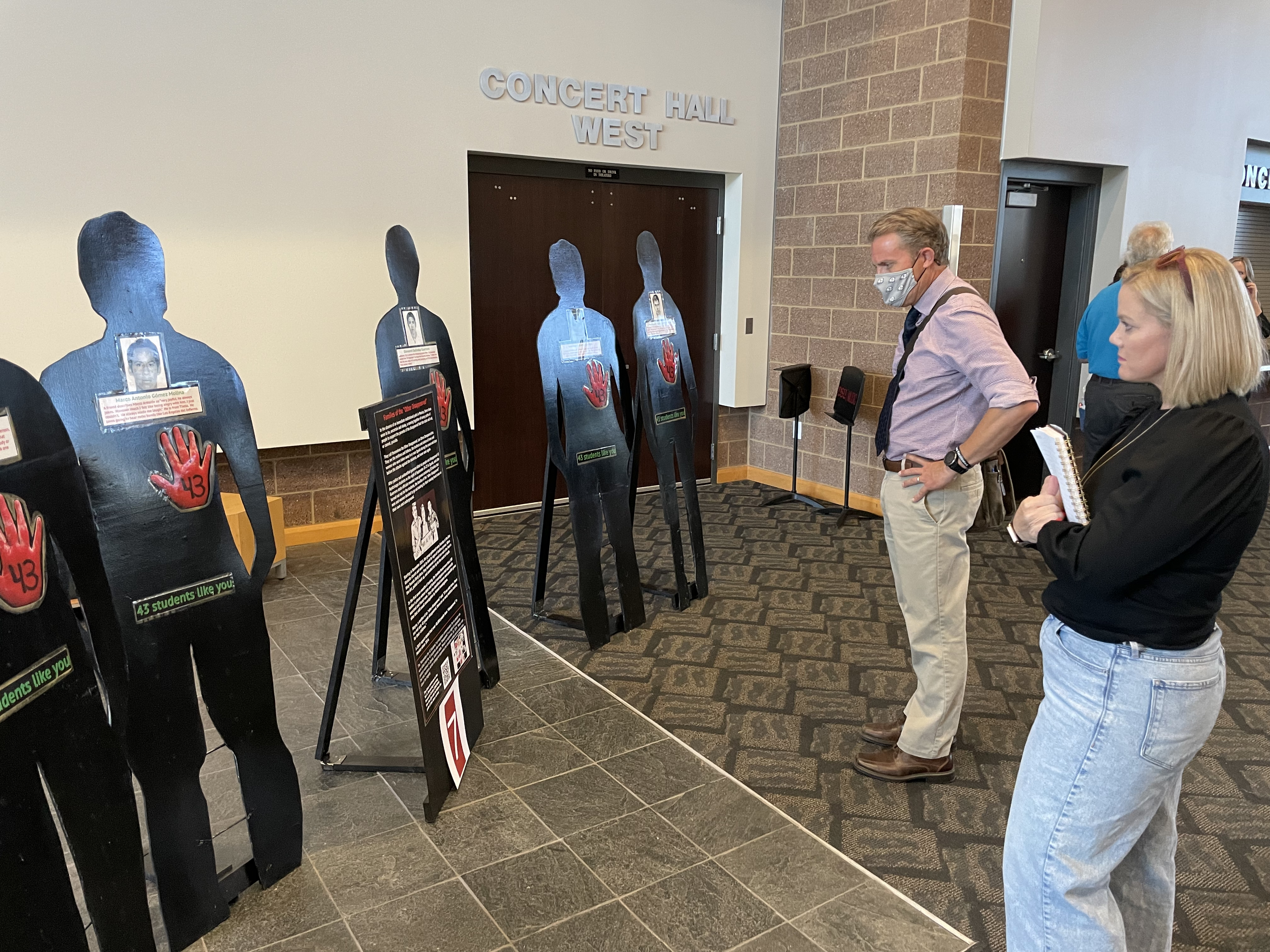 Brooke Ulrich and Kyle Wells view the "Remember the 43 Students" art installation at Dixie State University on Friday in honor of the college students who went missing in Mexico in 2014 during a mass kidnapping.