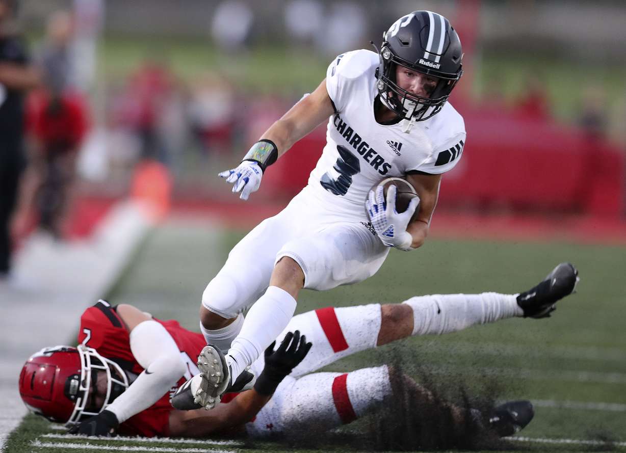 Corner Canyon’s Cody Hagen drives past American Fork’s Fisher Ingersoll at American Fork High School on Friday, Sept. 17, 2021.