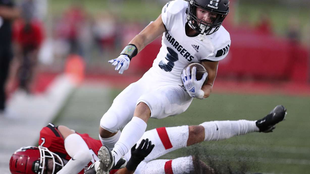 Corner Canyon’s Cody Hagen drives past American Fork’s Fisher Ingersoll at American Fork High School on Friday, Sept. 17, 2021.