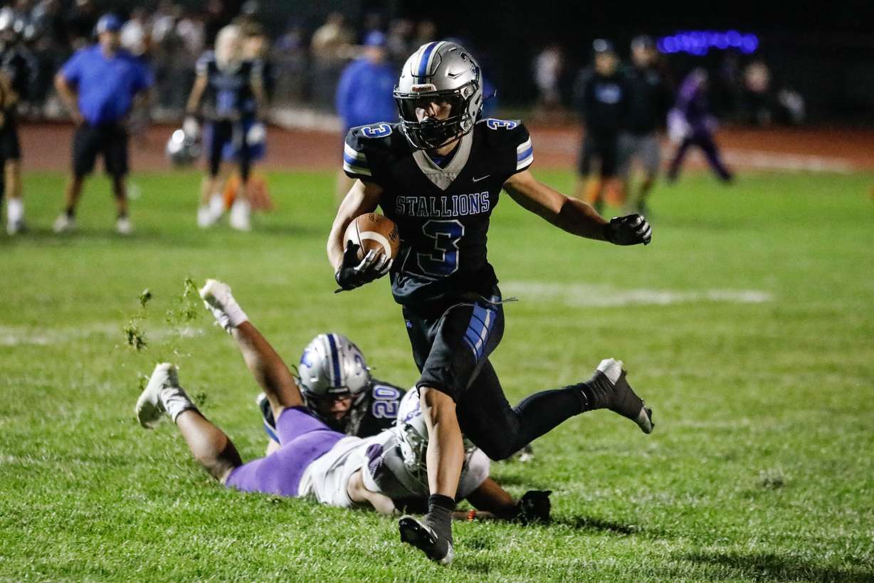 Stansbury’s Nate Bushnell (3) runs past Tooele’s defense for a touchdown during a high school football game at Stansbury High School in Stansbury Park on Friday, Sept. 17, 2021.