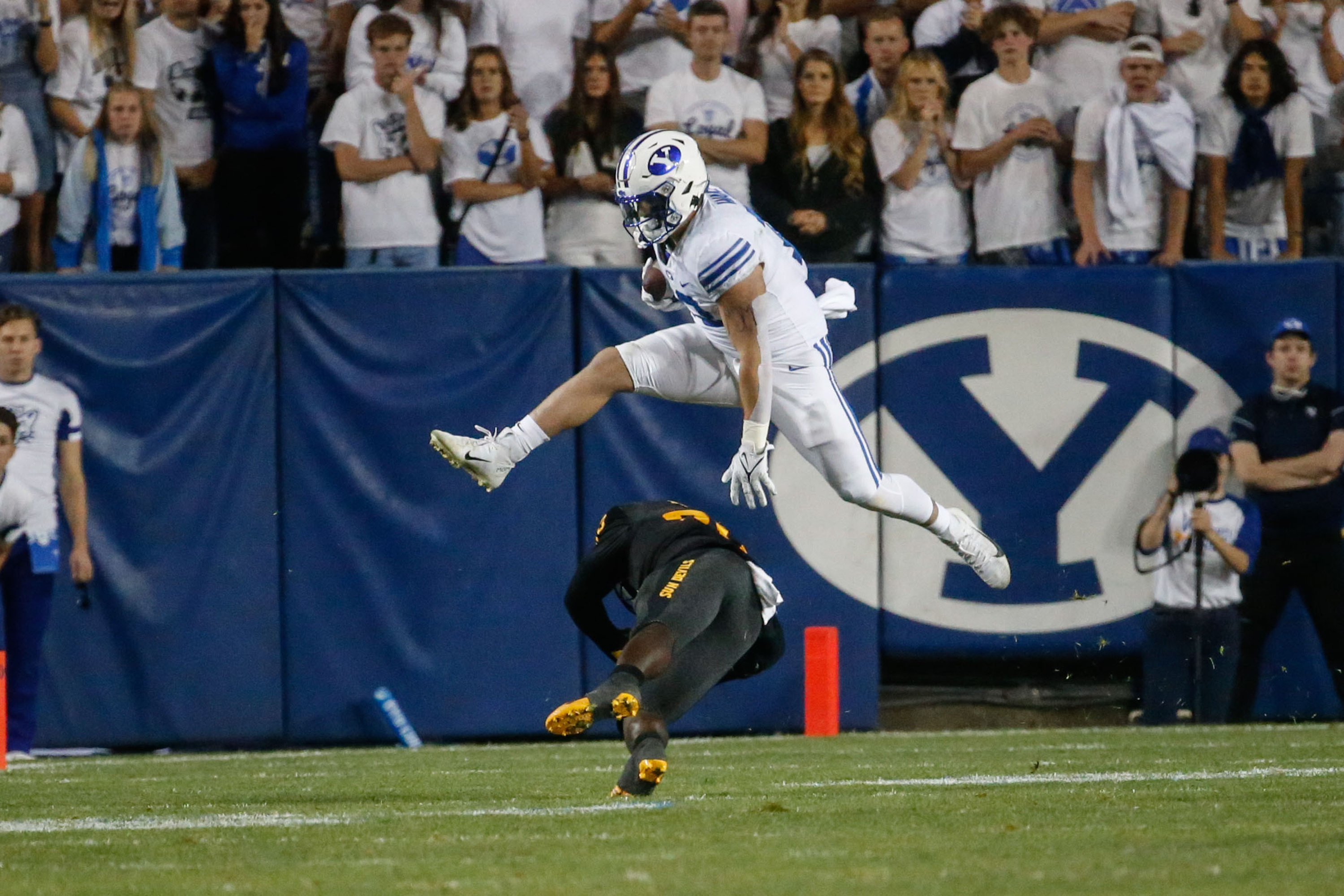 Brigham Young fullback Masen Wake, top, dodges a tackle by Arizona State's Giovanni Sanders (20) during an NCAA college football game at LaVell Edwards Stadium in Provo on Saturday, Sept. 18, 2021.