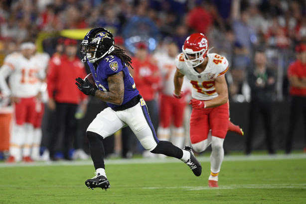 Baltimore Ravens running back Devonta Freeman, left, rushes past Kansas City Chiefs defensive back Daniel Sorensen in the first half of an NFL football game, Sunday, Sept. 19, 2021, in Baltimore.