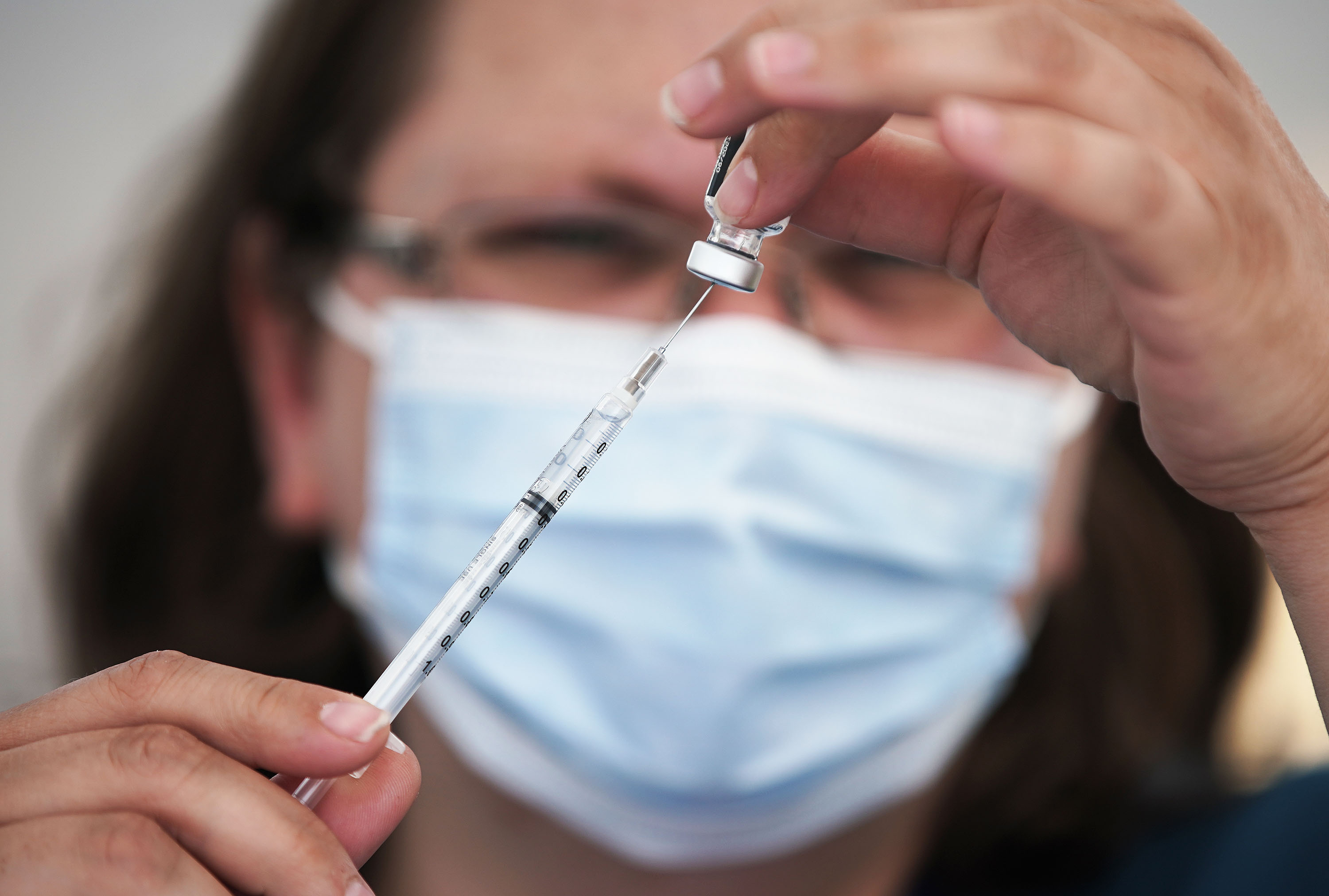Clarece Glanville prepares a COVID-19 vaccination at pop-up clinic sponsored by the Davis County Health Department in the parking lot of Kent's Market in Clearfield on June 23. U.S. regulators could authorize a booster shot of the Pfizer-BioNTech COVID-19 vaccine for older and some high-risk Americans early this week in time for the government to roll them out by Friday.
