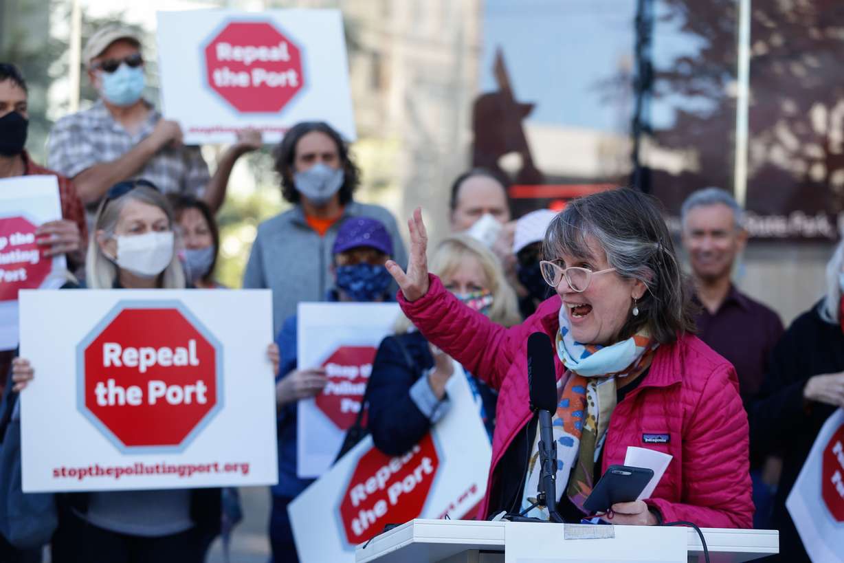 Deeda Seed, a member of Stop the Polluting Port Coalition, reacts while speaking during a press conference outside of the offices of the Utah Inland Port Authority in Salt Lake City on Monday, Sept. 20, 2021, as others hold signs protesting the port authority’s planned vote to adopt a public infrastructure district.