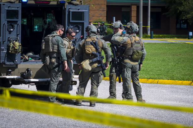 Members of the Virginia State Police SWAT Team gather behind a Bearcat tactical vehicle after clearing Heritage High School in Newport News, Va., Monday, Sept. 20, 2021, following a shooting at the school.