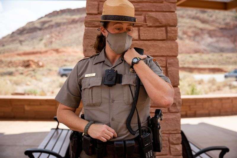 National Park Service ranger Melissa Hulls, the visitor
and resource protection supervisor for Arches National Park,
listens to a call on her radio outside of the park’s visitors
center on Sunday, Sept. 19, 2021.