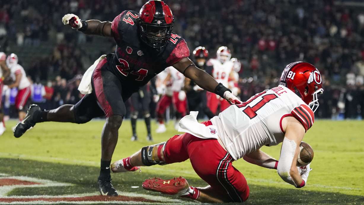 Utah wide receiver Connor O'Toole (81) tries to catch a pass in the end zone ahead of San Diego State linebacker Segun Olubi (24) during triple overtime of an NCAA college football game Saturday, Sept. 18, 2021, in Carson, Calif. The pass was ruled incomplete upon official review. San Diego State won 33-31.