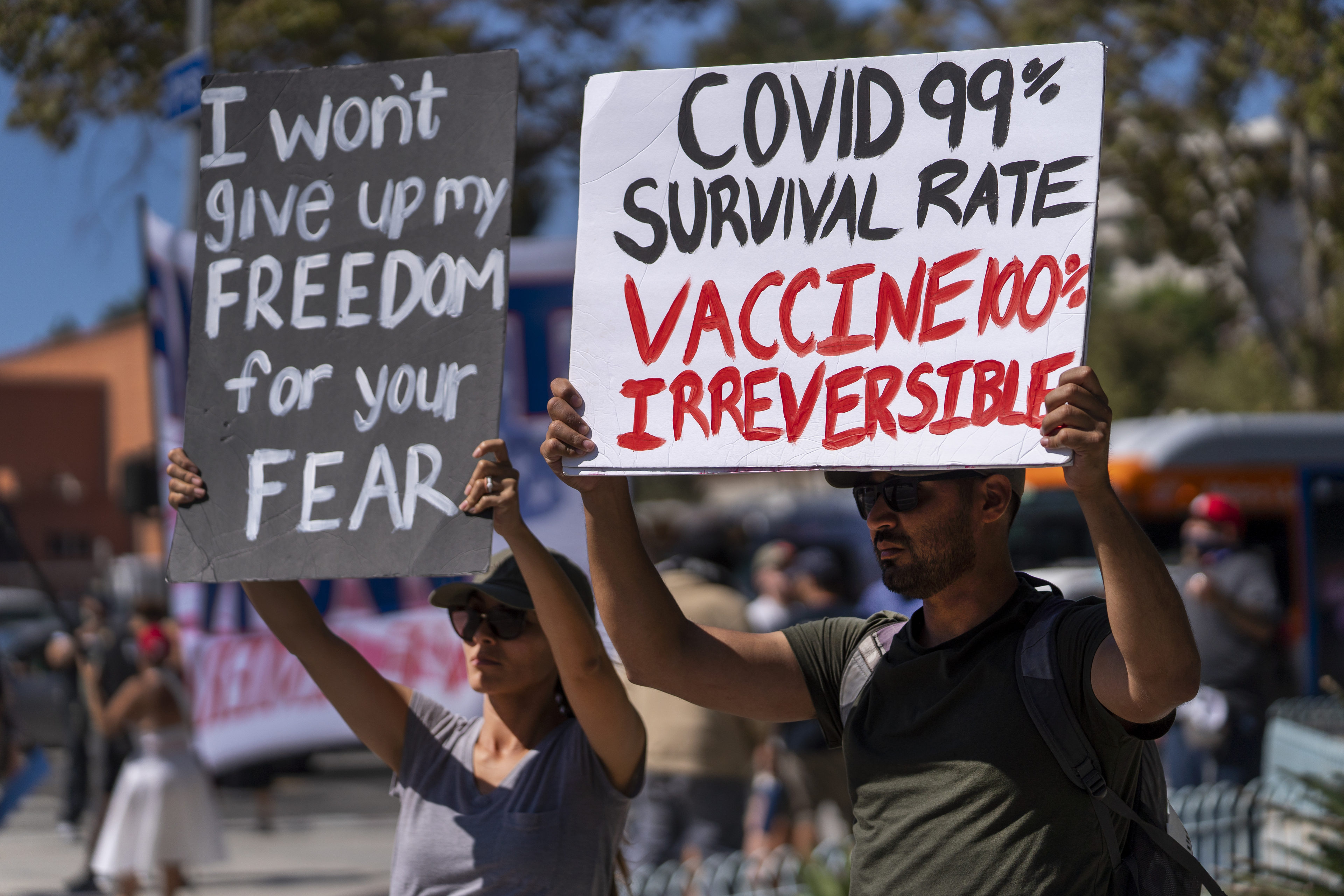 Protesters opposing COVID-19 vaccine mandates hold a rally in front of City Hall in downtown Los Angeles on Sept. 18. COVID-19 deaths in the U.S. have climbed to an average of more than 1,900 a day for the first time since early March, with experts saying the virus is preying largely on a select group: 71 million unvaccinated Americans.