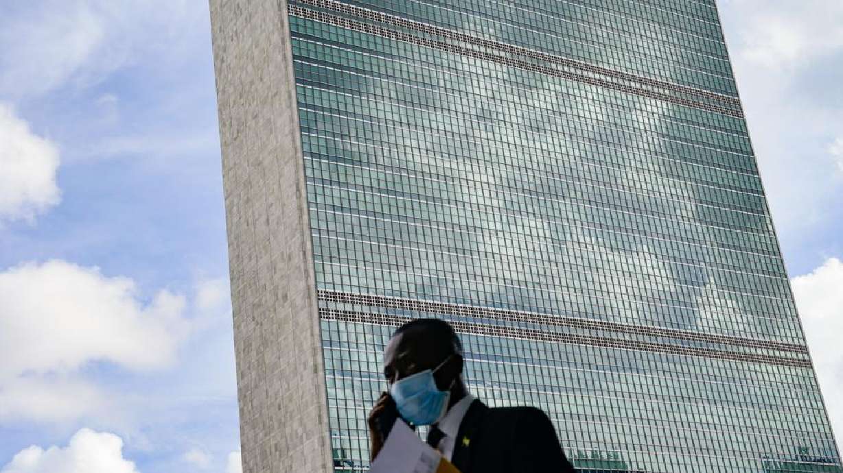 A pedestrian passes outside the United Nations headquarters Tuesday during the 76th Session of the U.N. General Assembly in New York. The new rulers of Afghanistan have an uphill battle in their efforts to be recognized in time to address other world leaders at the United Nations this year.