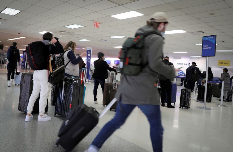 Travelers pack a United Airlines check-in area at Newark International Airport in Newark, New Jersey, on Nov. 25, 2020. The rate of unruly airline passenger incidents has dropped sharply since regulators moved to impose fines in January.